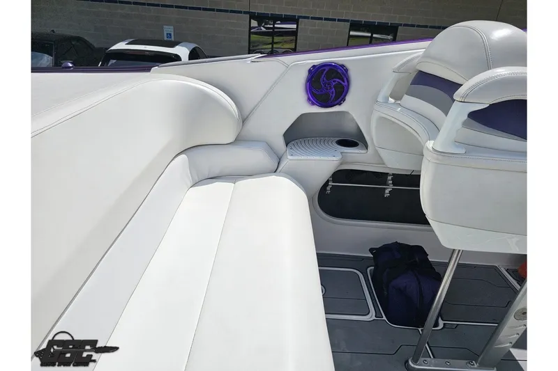 Slide: The Image of 2007 Sunsation 32 Dominator boat interior with white seating and purple speaker detail. - 46