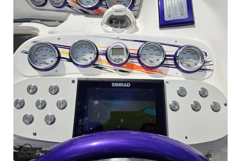 Slide: The Image of Dashboard of a 2007 Sunsation 32 Dominator boat with gauges and navigation display. - 59