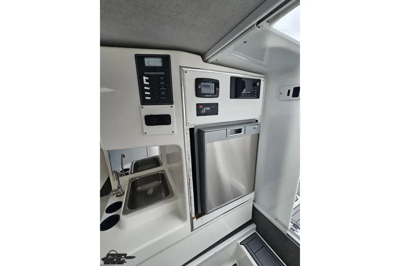 Slide: The Image of Interior view of 2007 Sunsation 32 Dominator boat featuring a compact kitchen area. - 72