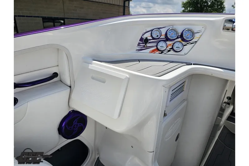 Slide: The Image of 2007 Sunsation 32 Dominator boat dashboard with gauges and storage compartment. - 49