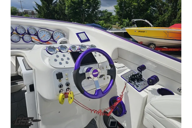 Slide: The Image of 2007 Sunsation 32 Dominator boat dashboard with purple accents and multiple gauges. - 56