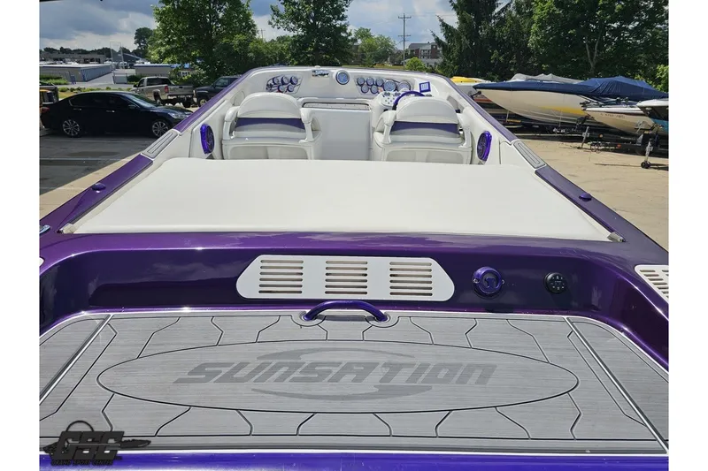 Slide: The Image of 2007 Sunsation 32 Dominator boat with purple accents, featuring a sleek cockpit and modern design. - 34