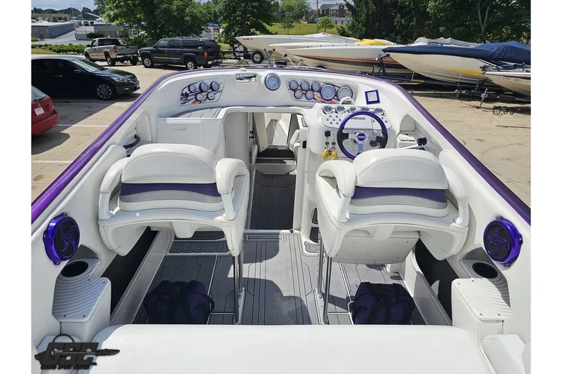 Slide: The Image of 2007 Sunsation 32 Dominator boat interior with white and purple seating, dashboard, and controls. - 39
