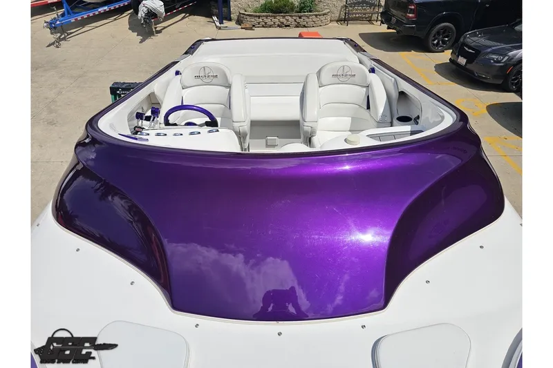 Slide: The Image of 2007 Sunsation 32 Dominator boat with purple and white interior, parked outdoors. - 65
