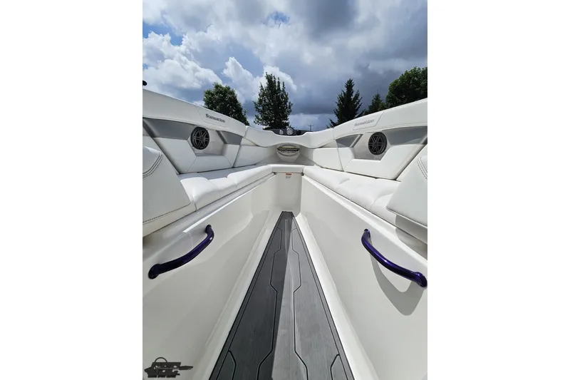 Slide: The Image of 2007 Sunsation 32 Dominator boat interior with white seating and cloudy sky backdrop. - 79