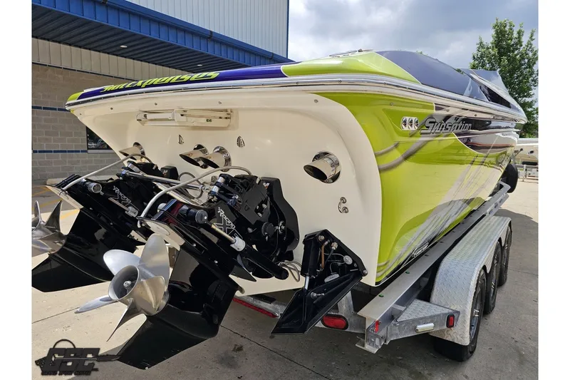 Slide: The Image of 2007 Sunsation 32 Dominator boat on trailer, showcasing vibrant green and white design. - 31