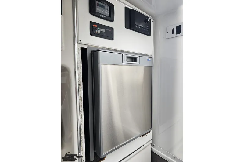 Slide: The Image of 2007 Sunsation 32 Dominator interior with stainless steel appliance and control panels. - 73