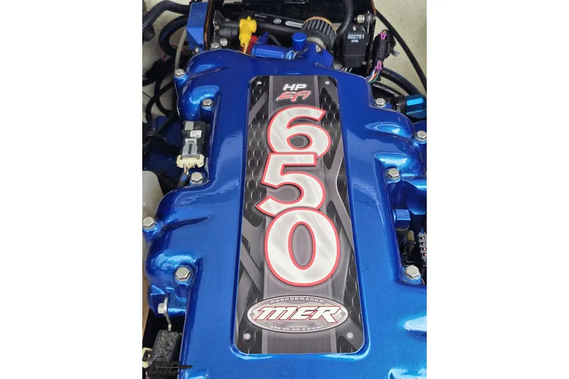 Slide: The Image of Close-up of a 2007 Sunsation 32 Dominator engine with "650 HP" label. - 102