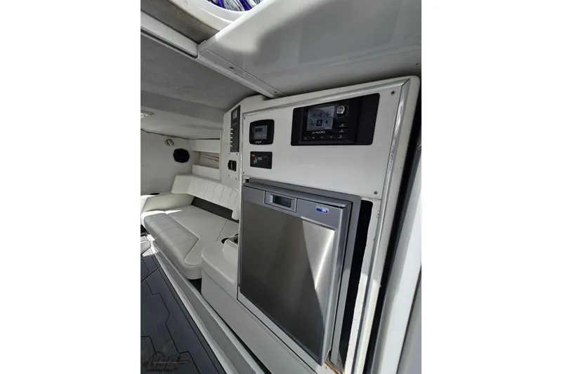 Slide: The Image of Interior of 2007 Sunsation 32 Dominator boat with white seating and modern control panel. - 68