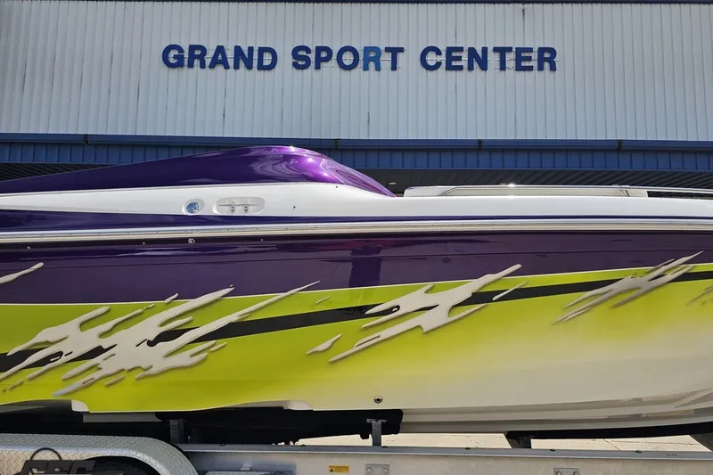 Slide: The Image of 2007 Sunsation 32 Dominator boat with vibrant purple and yellow design at Grand Sport Center. - 5