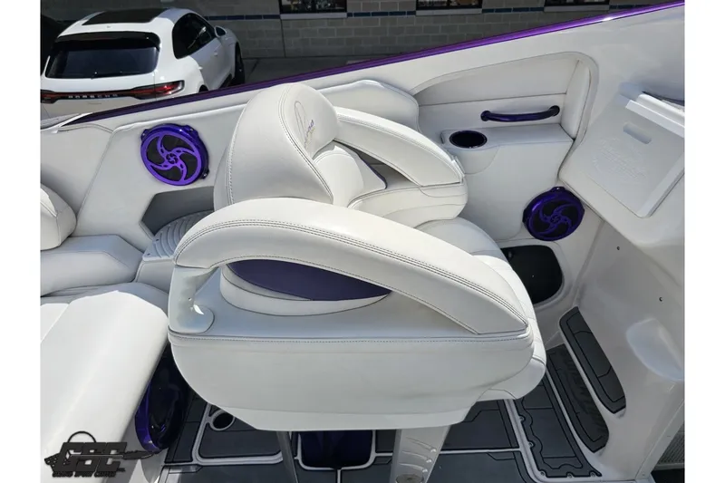 Slide: The Image of Interior of a 2007 Sunsation 32 Dominator boat with white seating and purple accents. - 47