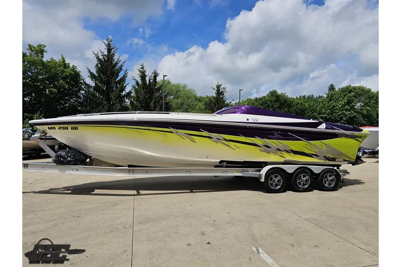 Slide: The Image of 2007 Sunsation 32 Dominator speedboat with vibrant yellow and purple design on a trailer. - 19