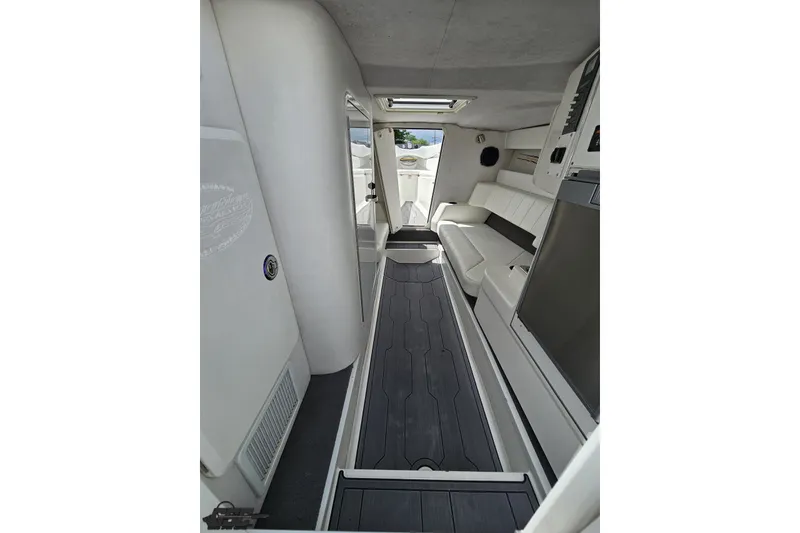 Slide: The Image of Interior of 2007 Sunsation 32 Dominator boat, featuring sleek white seating and modern design. - 67