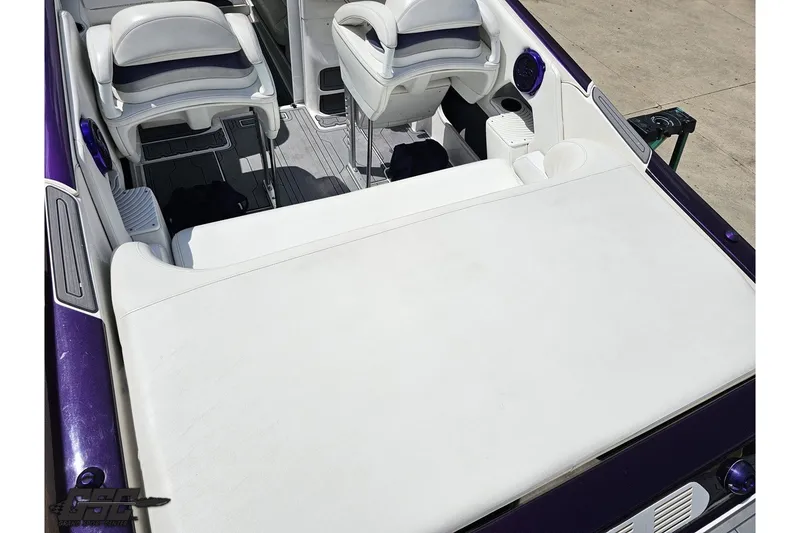 Slide: The Image of 2007 Sunsation 32 Dominator boat interior with white seating and purple accents. - 36
