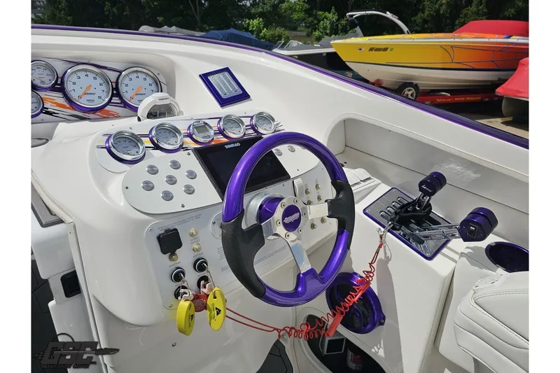 Slide: The Image of 2007 Sunsation 32 Dominator boat dashboard with gauges and purple accents. - 55