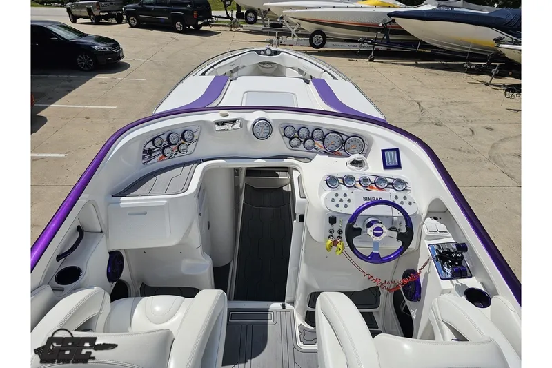 Slide: The Image of 2007 Sunsation 32 Dominator boat interior with purple accents and detailed dashboard controls. - 41