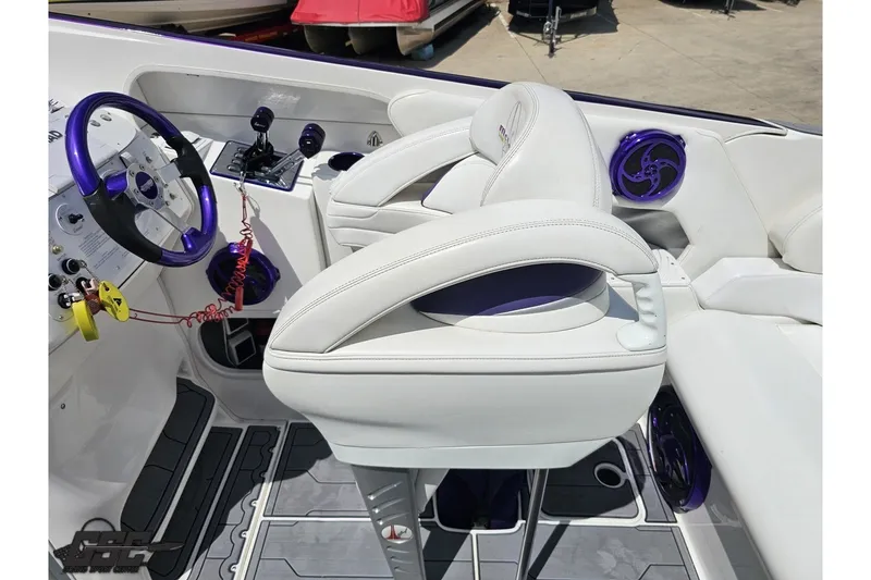 Slide: The Image of 2007 Sunsation 32 Dominator boat interior with white seats and purple accents. - 53