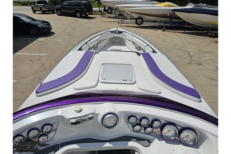 Slide: The Image of 2007 Sunsation 32 Dominator boat with purple accents and detailed dashboard gauges. - 62