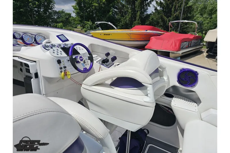 Slide: The Image of Interior of a 2007 Sunsation 32 Dominator boat with white and purple accents. - 45