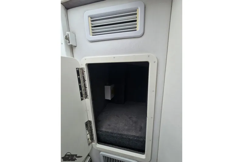 Slide: The Image of 2007 Sunsation 32 Dominator cabin interior with open storage compartment and vent. - 74