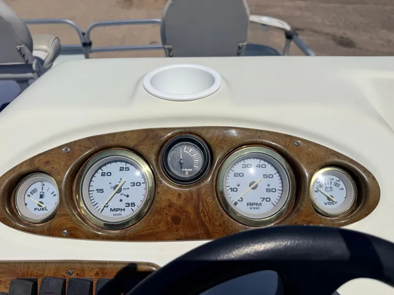 Slide: The Image of Dashboard of a boat with speedometer, tachometer, and fuel gauge. - 24