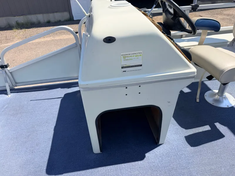 Slide: The Image of The image shows the cockpit of a 2004 Palm Beach 200 CastMaster boat with a helm and seat. - 21