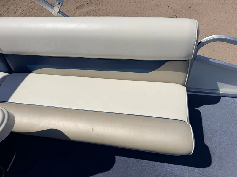 Slide: The Image of A cream-colored seat cushion on a boat, surrounded by blue flooring and metal railing. - 30