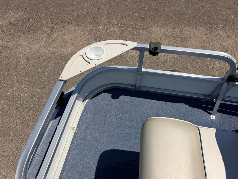 Slide: The Image of Part of a boat with blue carpet flooring and a beige seat on a metal frame. - 17
