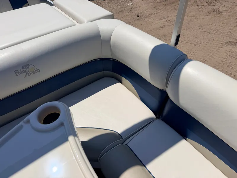 Slide: The Image of Close-up of white and blue upholstery on a Palm Beach boat, featuring a cup holder. - 31