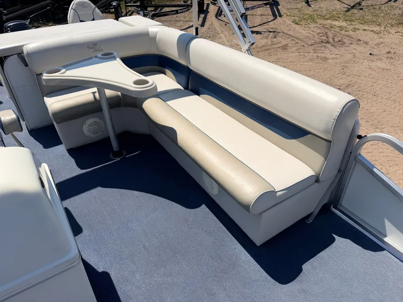 Slide: The Image of A 2004 Palm Beach 200 CastMaster with 50HP Mercury 4Stroke. It features a beige bench seat and small table. - 29