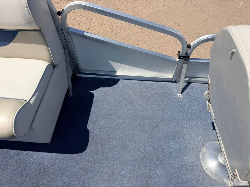 Slide: The Image of The image shows the interior of a 2004 Palm Beach 200 CastMaster boat with blue carpet and white seating. - 14