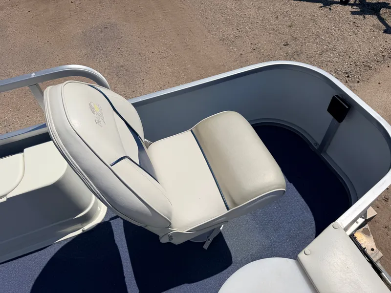 Slide: The Image of A white boat seat on a blue floor, surrounded by a metal railing. - 41