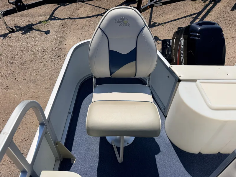 Slide: The Image of A boat seat with Palm Beach logo, surrounded by a clean deck and a Mercury engine. - 40