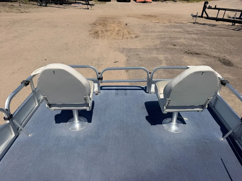 Slide: The Image of Two white seats on a blue carpeted deck of a boat, surrounded by metal railings. - 3