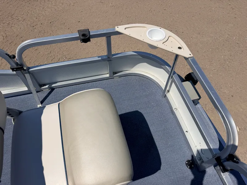 Slide: The Image of A boat with blue carpet flooring and a beige seat. It features a drink holder mount. - 13