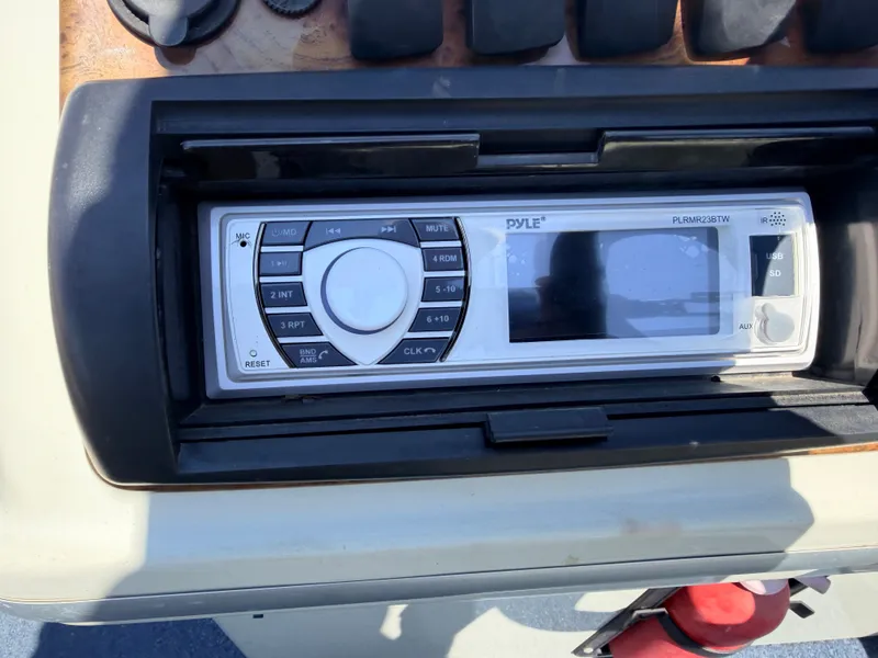 Slide: The Image of A helm console featuring a Dyle audio system, surrounded by controls and switches. - 25