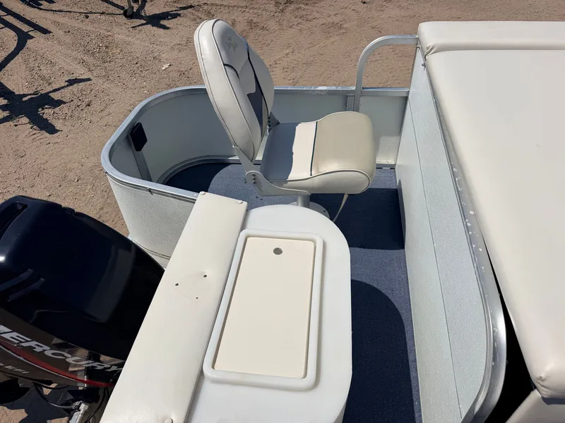 Slide: The Image of A 2004 Palm Beach model with a 50HP Mercury 4Stroke engine. It features a cushioned bench and helm chair. - 42