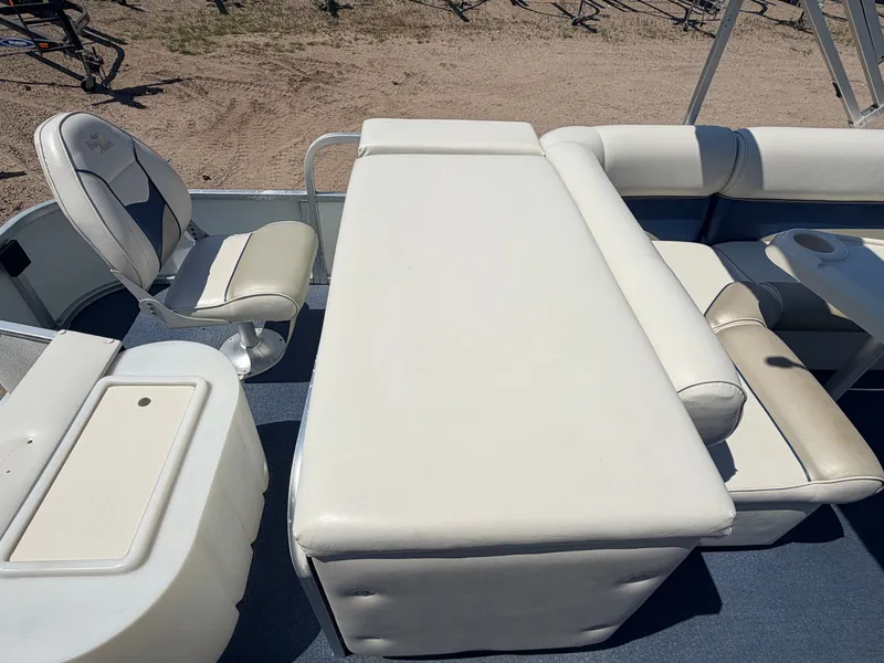 Slide: The Image of The image shows the interior of a 2004 Palm Beach 200 CastMaster boat with white upholstered seating. - 35