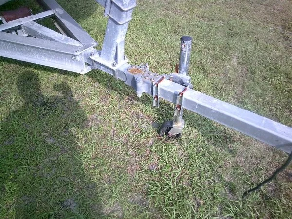 Slide: The Image of A boat trailer on grass with a sturdy metal frame and a support wheel. - 8