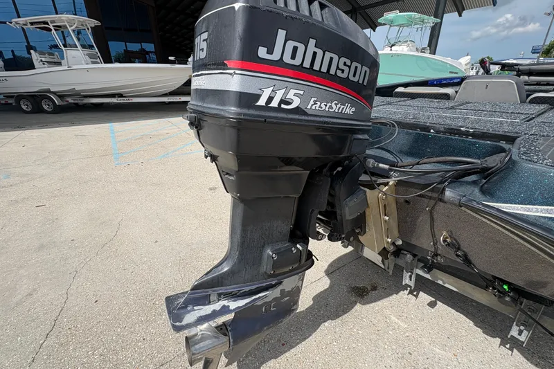 Slide: The Image of 1998 Triton Tr-17 boat with Johnson 115 FastStrike outboard motor in a marina setting. - 20