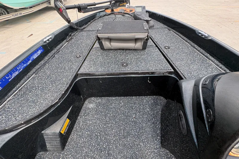 Slide: The Image of 1998 Triton Tr-17 boat interior with textured flooring and storage compartments. - 15