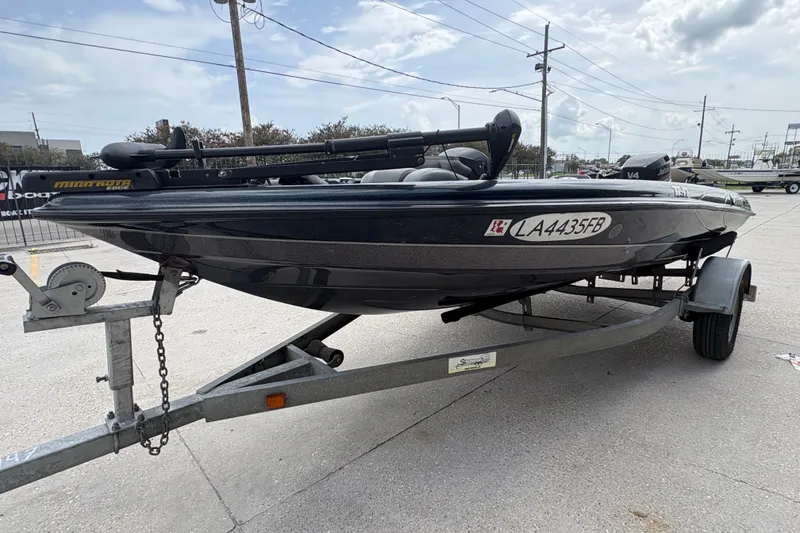 Slide: The Image of 1998 Triton Tr-17 boat on trailer, parked outdoors under cloudy sky. - 7