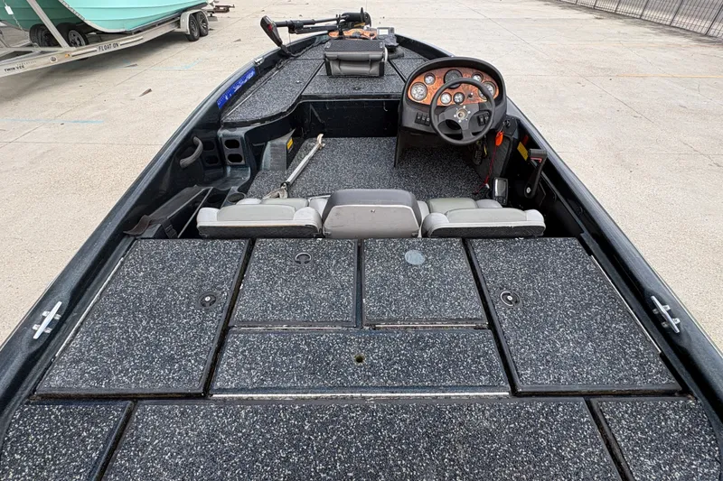 Slide: The Image of 1998 Triton Tr-17 boat interior with steering wheel and storage compartments. - 11