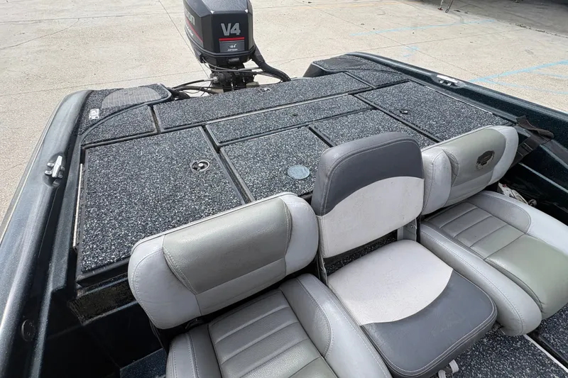 Slide: The Image of 1998 Triton Tr-17 boat interior with V4 engine and gray seating. - 14