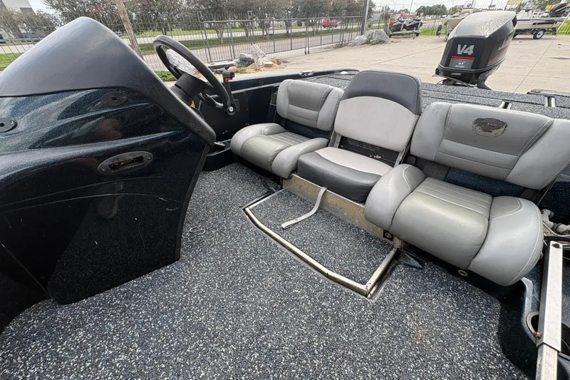 Slide: The Image of 1998 Triton Tr-17 boat interior with steering wheel and seating. - 12