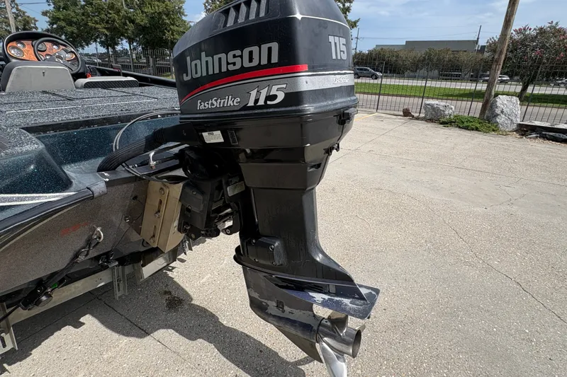 Slide: The Image of 1998 Triton Tr-17 boat with Johnson FastStrike 115 outboard motor in a parking lot. - 19
