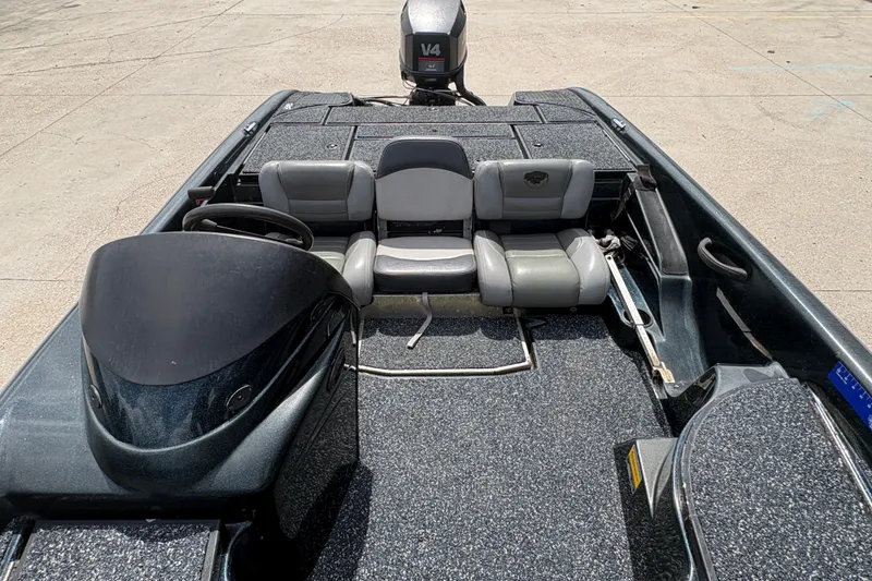 Slide: The Image of 1998 Triton Tr-17 boat interior with seating and steering console, featuring a V4 engine. - 17