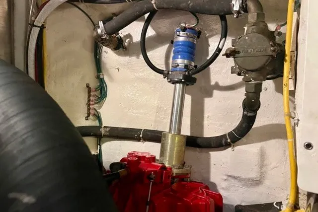 Slide: The Image of Engine room of 2004 Carver 420 Mariner with visible mechanical components and hoses. - 29
