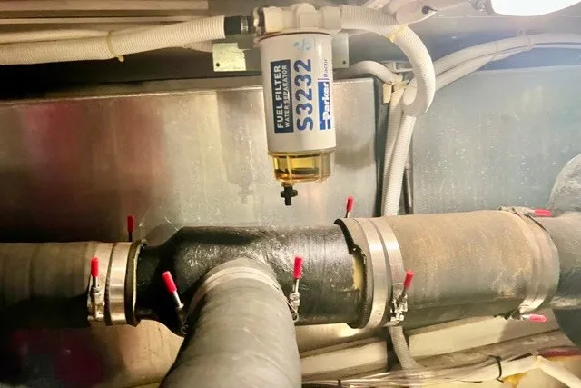 Slide: The Image of Fuel filter system in 2004 Carver 420 Mariner engine room with hoses and clamps. - 34