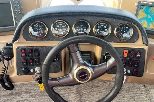 Slide: The Image of Helm of 2004 Carver 420 Mariner with gauges, controls, and navigation equipment. - 13